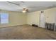 Bright bonus room featuring neutral walls, carpet, ceiling fan, window, and access door at 243 Donatella Dr, Goose Creek, SC 29445