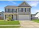 Attractive two-story house with a well-kept lawn, driveway, and welcoming front porch at 243 Donatella Dr, Goose Creek, SC 29445