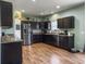 Spacious kitchen with sleek, dark cabinetry, stainless steel appliances, and hardwood floors at 243 Donatella Dr, Goose Creek, SC 29445