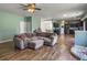 Living room with hardwood floors, ceiling fan, and open access to the kitchen at 243 Donatella Dr, Goose Creek, SC 29445