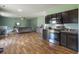 Open-concept kitchen and living room area with hardwood floors and dark cabinets at 243 Donatella Dr, Goose Creek, SC 29445