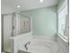 Large soaking tub and separate glass shower enhance this home's luxurious primary bathroom at 255 Longford Dr, Summerville, SC 29483