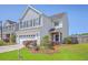 Charming two-story home with a well-manicured lawn and an attached two-car garage at 255 Longford Dr, Summerville, SC 29483