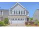 Two-story home featuring gray siding, a two-car garage, and attractive landscaping at 255 Longford Dr, Summerville, SC 29483