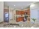 Well-lit kitchen with granite countertops, stainless steel appliances, and wooden cabinets at 255 Longford Dr, Summerville, SC 29483