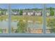 Window view of a peaceful pond surrounded by houses in a quiet neighborhood at 255 Longford Dr, Summerville, SC 29483