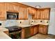 A modern kitchen with wooden cabinets, granite countertops, and a stainless steel sink at 259 E. Bay St # 1A, Charleston, SC 29401