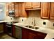 A modern kitchen with wooden cabinets, granite countertops, and stainless steel appliances at 259 E. Bay St # 1A, Charleston, SC 29401