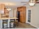An open kitchen with a breakfast bar, wooden cabinets, granite countertops, and stainless appliances at 259 E. Bay St # 1A, Charleston, SC 29401