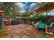 Spacious backyard with brick-paved patio, table and chairs, barbecue grill, and privacy fence at 29 Meander Row, Charleston, SC 29412