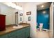 Traditional bathroom with vanity, toilet, and bright blue accent wall at 29 Meander Row, Charleston, SC 29412