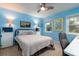 Bedroom with blue walls, a bed, and windows providing natural light at 29 Meander Row, Charleston, SC 29412