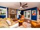 Inviting living room with a cozy fireplace, plush seating, and a large ceiling fan at 29 Meander Row, Charleston, SC 29412