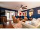 Inviting living room with a cozy fireplace, plush seating, and a large ceiling fan at 29 Meander Row, Charleston, SC 29412