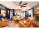 Inviting living room with a cozy fireplace, plush seating, and a large ceiling fan at 29 Meander Row, Charleston, SC 29412