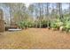 Large backyard with mature trees, a wooden deck, and boat at 298 Hook Ln, Mount Pleasant, SC 29464