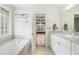 Well-lit bathroom with soaking tub, marble countertops and cabinets at 298 Hook Ln, Mount Pleasant, SC 29464