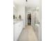 Bright bathroom with a marble topped vanity, tiled floor, and glass enclosed shower, adjacent to a walk-in closet at 298 Hook Ln, Mount Pleasant, SC 29464