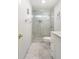 Bright bathroom features a glass-enclosed shower, white toilet, and marble tiled floors at 298 Hook Ln, Mount Pleasant, SC 29464