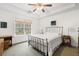 Inviting bedroom with a wrought iron bed frame, tray ceiling, and a large window for natural light at 298 Hook Ln, Mount Pleasant, SC 29464