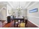 Dining room with a tray ceiling, modern chandelier, and picture window providing lots of natural light at 298 Hook Ln, Mount Pleasant, SC 29464