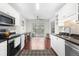 Bright kitchen with white cabinets, stainless appliances and a view to the breakfast area at 298 Hook Ln, Mount Pleasant, SC 29464