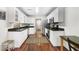 Bright kitchen with stainless steel appliances, white cabinets and view to the dining area at 298 Hook Ln, Mount Pleasant, SC 29464