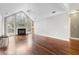 Bright living room featuring large arched windows, fireplace, ceiling fan, and gleaming hardwood floors at 298 Hook Ln, Mount Pleasant, SC 29464