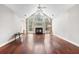 Bright living room with large arched windows, fireplace, ceiling fan, and hardwood floors at 298 Hook Ln, Mount Pleasant, SC 29464