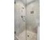 Modern glass enclosed shower featuring marble tile, a built-in shelf, and a rain shower head at 298 Hook Ln, Mount Pleasant, SC 29464