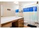 Well-lit bathroom with a large mirror, spacious vanity, and a shower-tub combo at 306 Todder Trl, Goose Creek, SC 29445