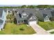 Two-story home featuring a two-car garage, manicured lawn, and traditional architectural details at 306 Todder Trl, Goose Creek, SC 29445