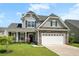 Charming two-story home with stone accents, landscaped yard, and a two-car garage at 306 Todder Trl, Goose Creek, SC 29445