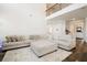 Bright living room features a large sectional sofa, high ceilings, and hardwood floors at 306 Todder Trl, Goose Creek, SC 29445