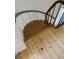Bright stairway leading to the second floor, featuring refinished hardwood steps and a curved railing at 330 Concord St # Th 9, Charleston, SC 29401