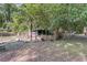 Backyard featuring overgrown vegetation and small wooden outbuilding at 3484 Johan Blvd, Johns Island, SC 29455