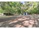 Large backyard area featuring mature tree coverage and several outbuildings at 3484 Johan Blvd, Johns Island, SC 29455