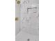 Luxurious shower showcases marble tile and gold fixtures, adding a touch of elegance at 3484 Johan Blvd, Johns Island, SC 29455