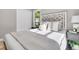 Stylishly staged bedroom featuring a decorative headboard and bright, natural light at 3484 Johan Blvd, Johns Island, SC 29455