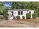 Charming cottage-style home with fresh white exterior and landscaping at 3484 Johan Blvd, Johns Island, SC 29455