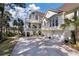 Two-story coastal home with a large driveway, private balconies, lovely landscaping, and a two-car garage at 3600 Henrietta Hartford Rd, Mount Pleasant, SC 29466