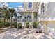Two-story coastal home with a large driveway, private balconies, lovely landscaping, and a two-car garage at 3600 Henrietta Hartford Rd, Mount Pleasant, SC 29466