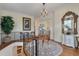 Elegant foyer with hardwood floors, chandelier, staircase, and decorative rug at 3600 Henrietta Hartford Rd, Mount Pleasant, SC 29466