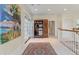 Hallway featuring wood cabinet with mini fridge, an eclectic art piece, and access to the outside and other rooms at 3600 Henrietta Hartford Rd, Mount Pleasant, SC 29466