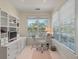 Bright home office with natural light, built-in shelving, and a glass top desk at 3600 Henrietta Hartford Rd, Mount Pleasant, SC 29466