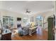 Spacious living room with fireplace, large windows, hardwood floors, and a ceiling fan at 3600 Henrietta Hartford Rd, Mount Pleasant, SC 29466