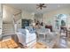 Bright living room with staircase, comfortable seating, ceiling fan, and French doors to exterior at 3600 Henrietta Hartford Rd, Mount Pleasant, SC 29466