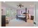 Main bedroom with a four-poster bed, ceiling fan, large windows, and soft lilac walls at 3600 Henrietta Hartford Rd, Mount Pleasant, SC 29466