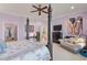 Main bedroom with four-poster bed, sitting area, television, and soft lilac walls at 3600 Henrietta Hartford Rd, Mount Pleasant, SC 29466