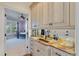 Wet bar area with cream cabinets and golden granite countertops, leading to a bedroom at 3600 Henrietta Hartford Rd, Mount Pleasant, SC 29466